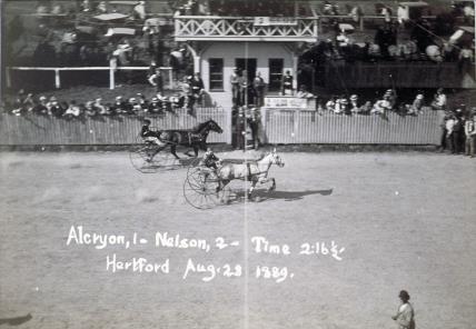 Vintage harness race with sulkies, spectators